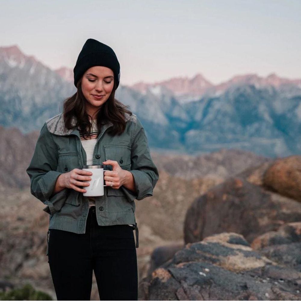 Girl drinking coffee in the mountains