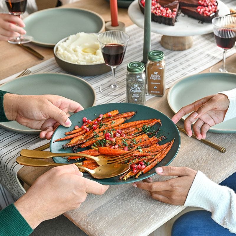 Passing a plate of carrots at dinner table